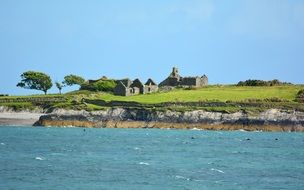 ruins of a building on a green coast