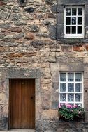 old stone house with lattice Windows And wooden Door