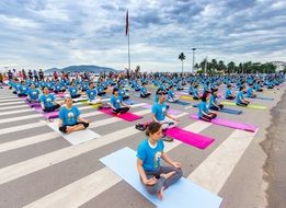 people are doing yoga in the town square