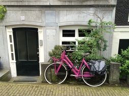 pink bike near the building