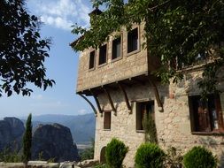 Monastery building among the colorful plants, Meteora, Greece