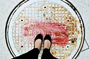 feet on the sewer hatch