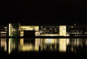 buildings reflected on water at night