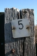 Five number sign on a wood