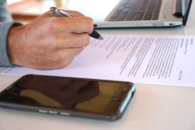 man hand with pen on office papers