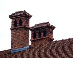 brick chimneys on a tiled roof