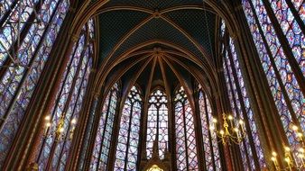 beautiful and colorful stained glass windows and candle in the Holy Chapel in Paris