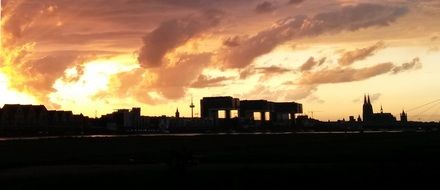 sunset over city skylines in cologne