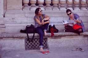 friends are sitting on the steps