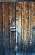 wooden door with rusty lock