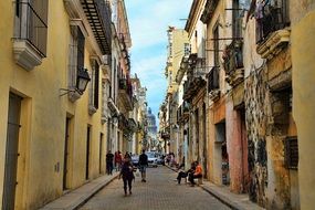 Walking people on alley in Cuba