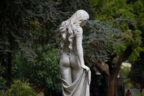 beautiful woman like a statue in a park