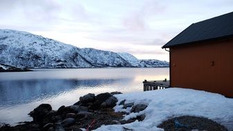 fishing house by the river in winter