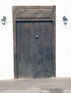 Old wooden door of the white building