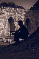 silhouette of a sitting man in india