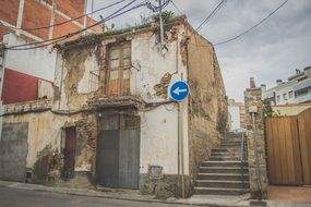 road sign on a house on an old street