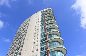 residential tower at blue sky background with white clouds in Lisbon, Portugal