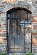 wooden entrance door to an old brick house