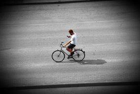 Human riding on a bike and looking at phone