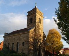 green trees near the medieval church