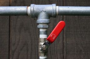 galvanized pipe with red tap