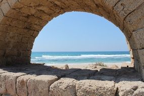 view through a stone arch on the mediterranean coast in israel