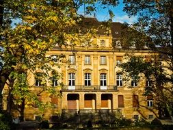 facade of an old house among the autumn landscape