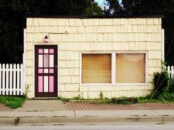 pink door of a small brick house