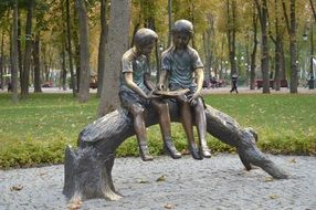 statue of two boys in the park