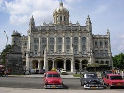 old cars near the historic building