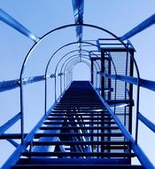 fenced metal ladder of tower Crane at sky