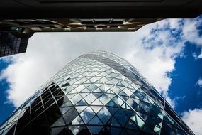 sky reflections in the facade of an office building