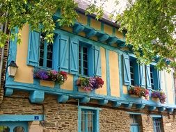 blue wooden staves on the windows of a medieval building