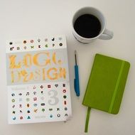 notebooks with pen near cup of coffee on the table