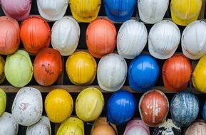 lot of Colorful weathered Construction Helmets