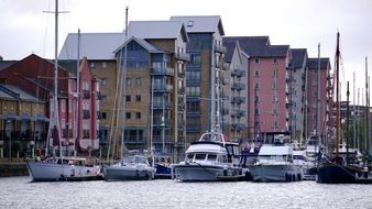 sailing boats in the harbor on the background of colorful houses