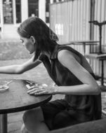 Black and white photo of girl in a cafe