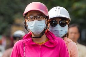 Riding on the scooter with the masks