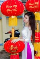 girl stands near chinese lanterns