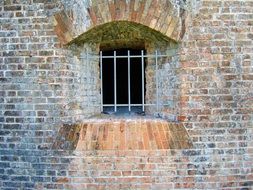 barred window on brick wall