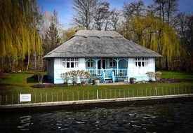 thatched cottage by the river