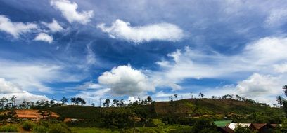 village under scenic clouds at summer, panorama view