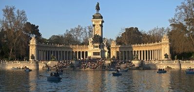 people resting in Parque del Retiro in spain, madrid