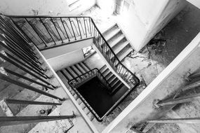 black and white picture of a staircase if an abandoned house