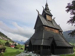 medieval Stave Church in scenic summer landscape, Norway