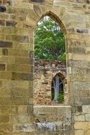 arched window in the ruins of a church