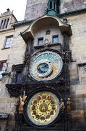 antique clock on the facade of a building in Prague