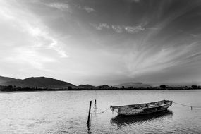 boat on a calm sea in black and white background