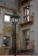 vintage street lantern in front of ruined building