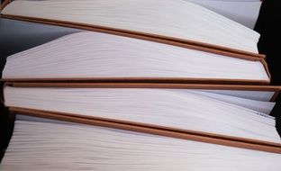 closeup view of many books with white pages